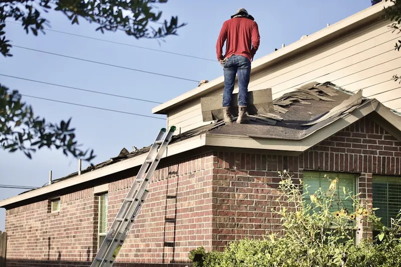 Professional roofer working on a residential roof in Buckingham Village
